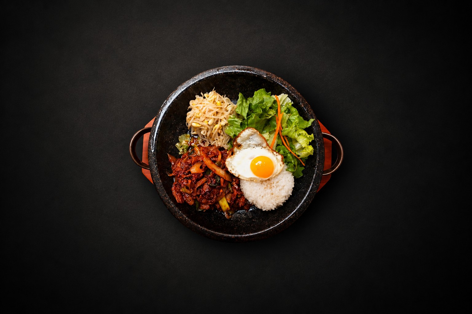 Rice, vegetables, and meat arranged in a dark bowl